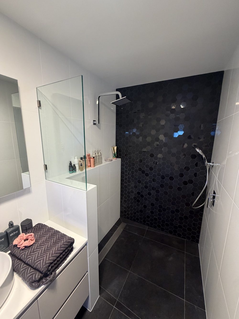 Bathroom with black feature tile shower